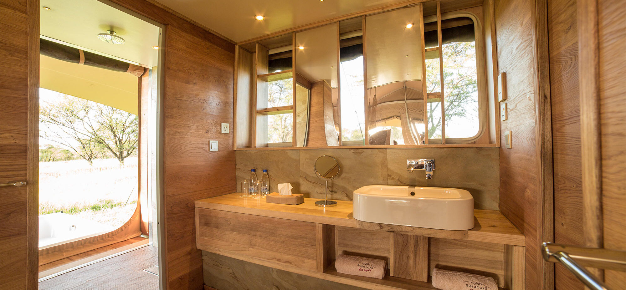 Bathroom counter top with sink, mirrors and towels