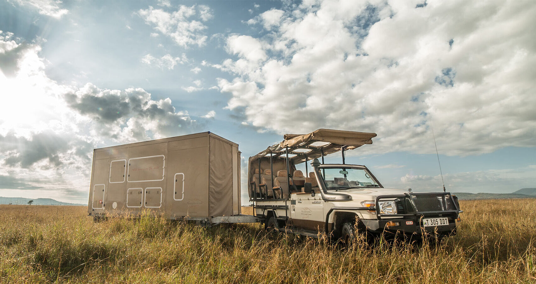 Roving tent packed away and attached to a jeep for transport