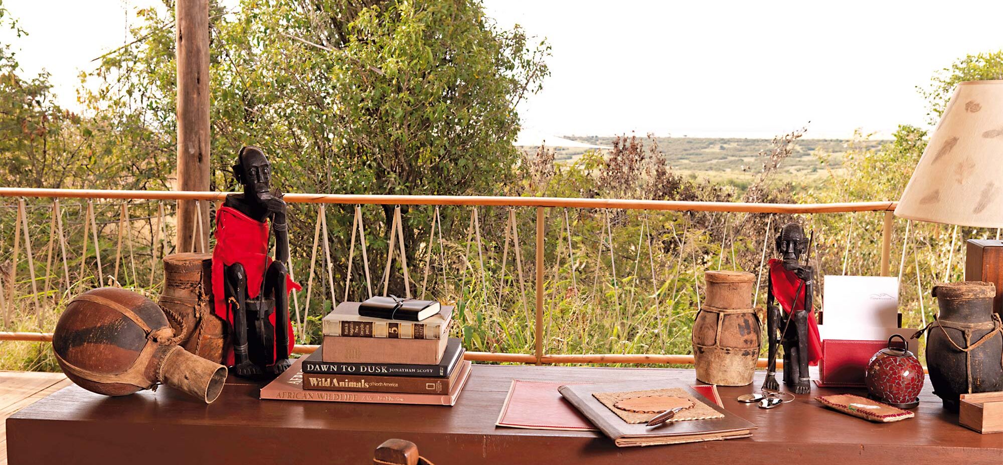 A close up of a desk with African decor overlooking the conservancy