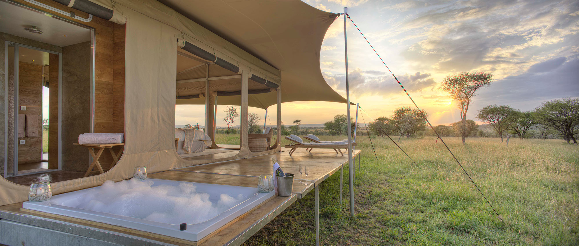 Sun setting on the private hot tub on the roving tent deck