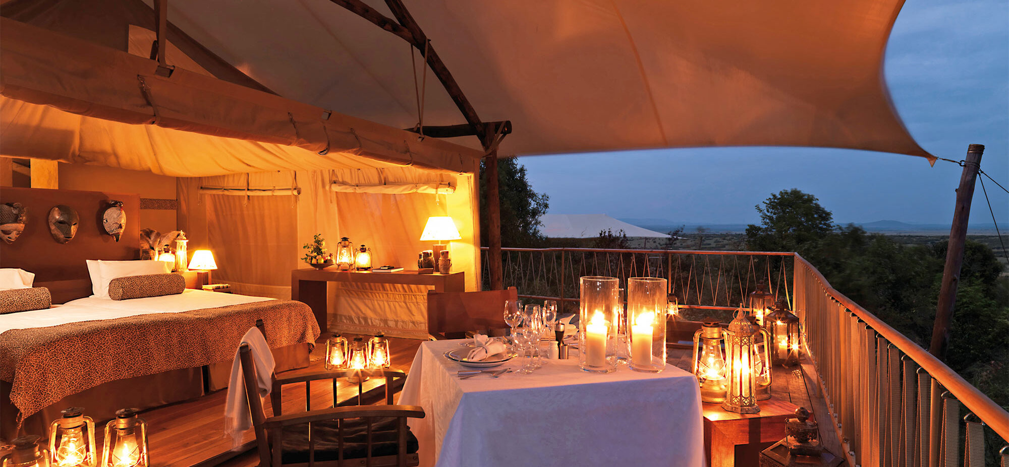 A candlit table setup and ready for dinner on the tent deck