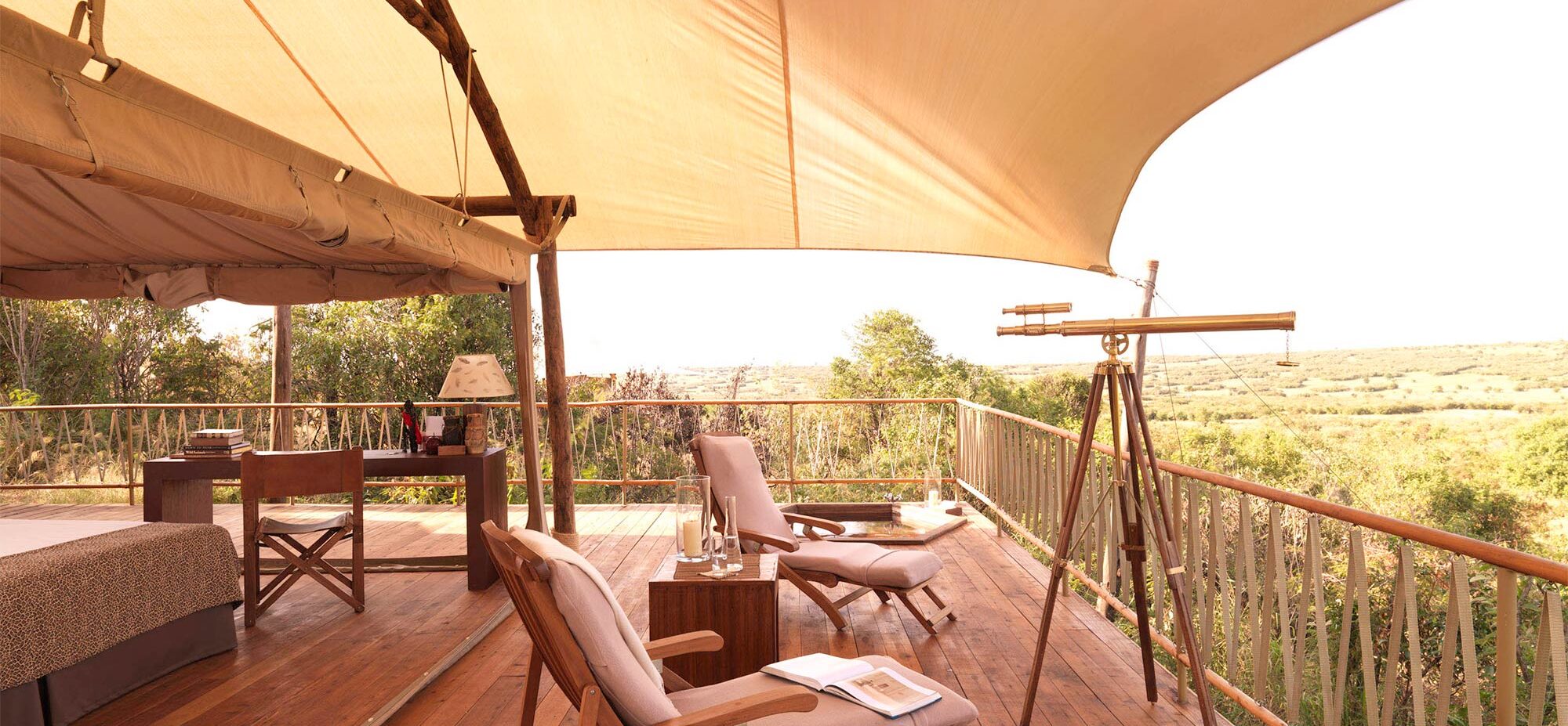 Two chairs on the tent deck looking at the sunrise