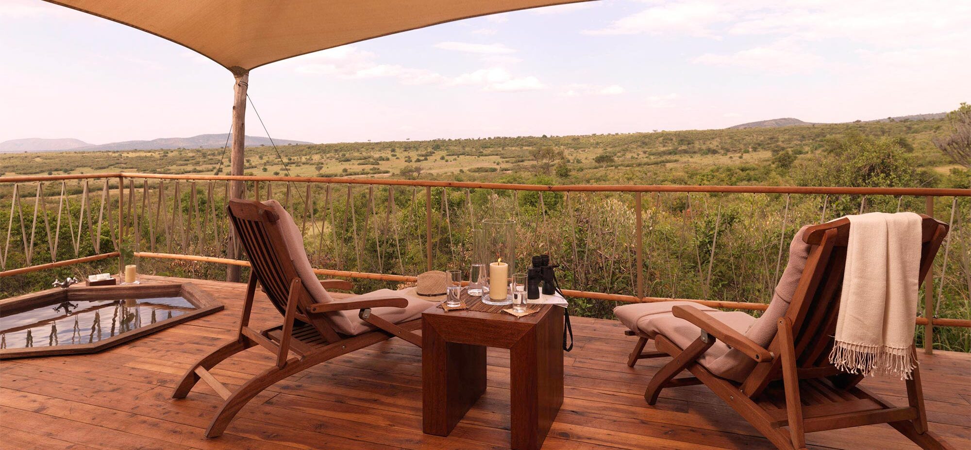 Two chairs on the tent deck with the conservancy in the background