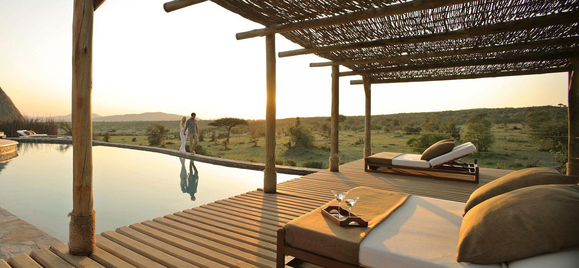 A couple walks along the edge of the infinity pool