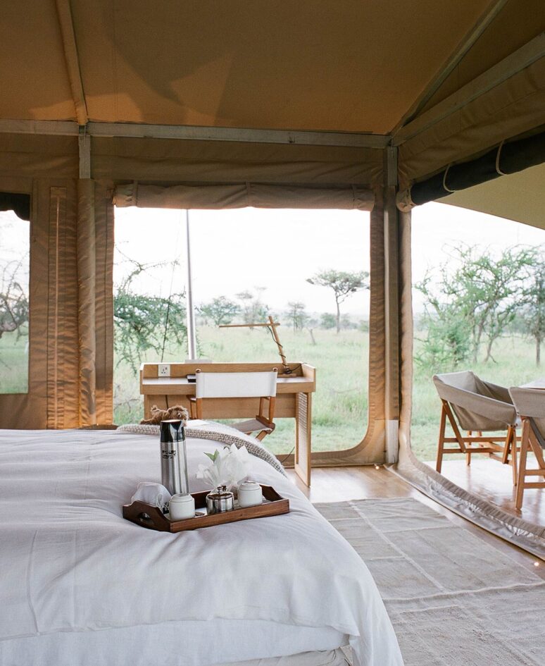 A breakfast tray sits at the edge of a bed