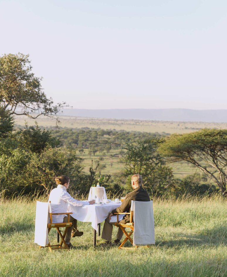 A couple enjoy breakfast watching the sunrise