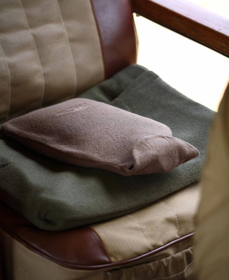 A hot water bottle sitting on a seat
