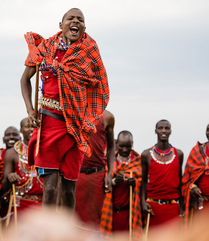 a maasai man performing a renewal ceremony dance