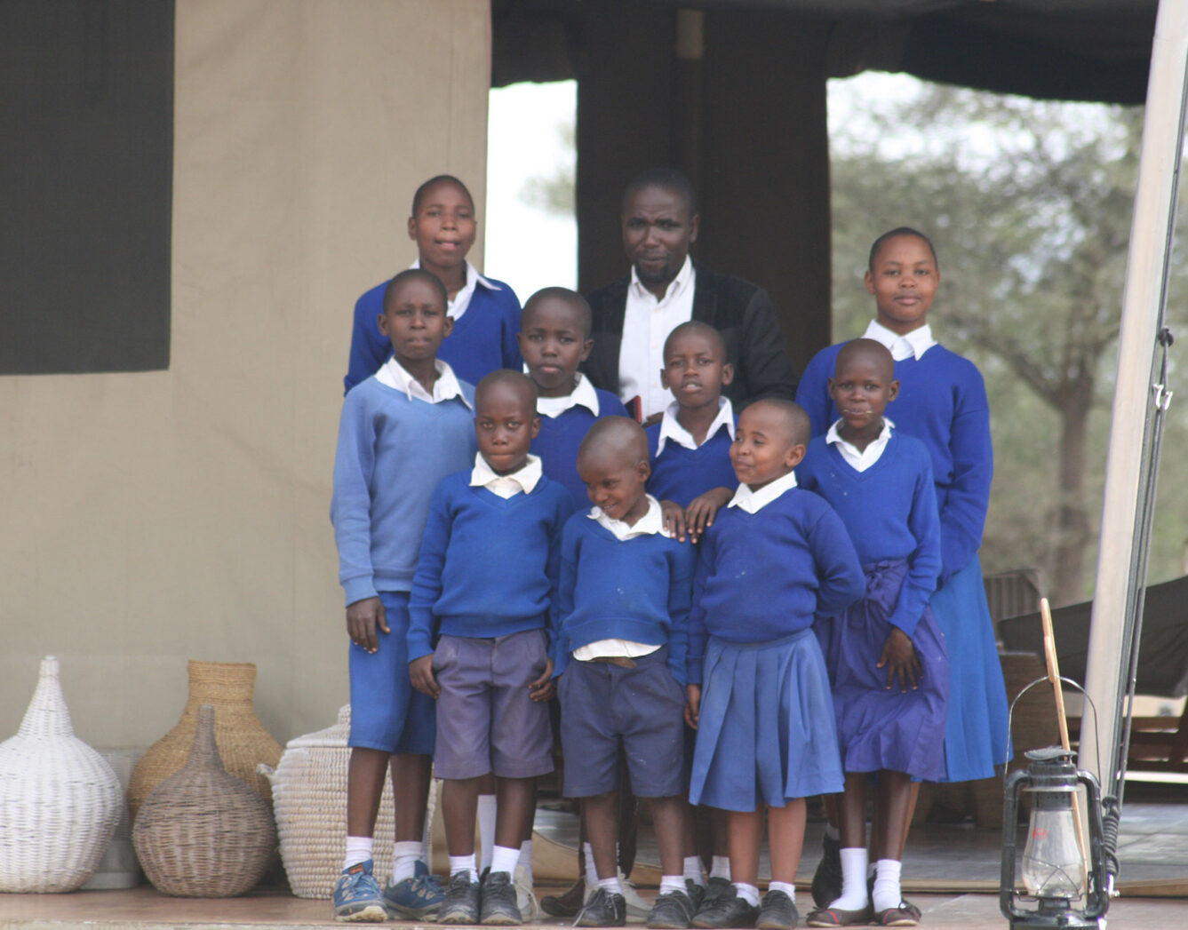 A teacher stands with a group of their students