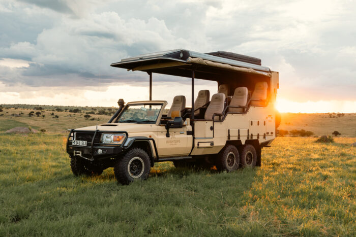 safari vehicle at sunset