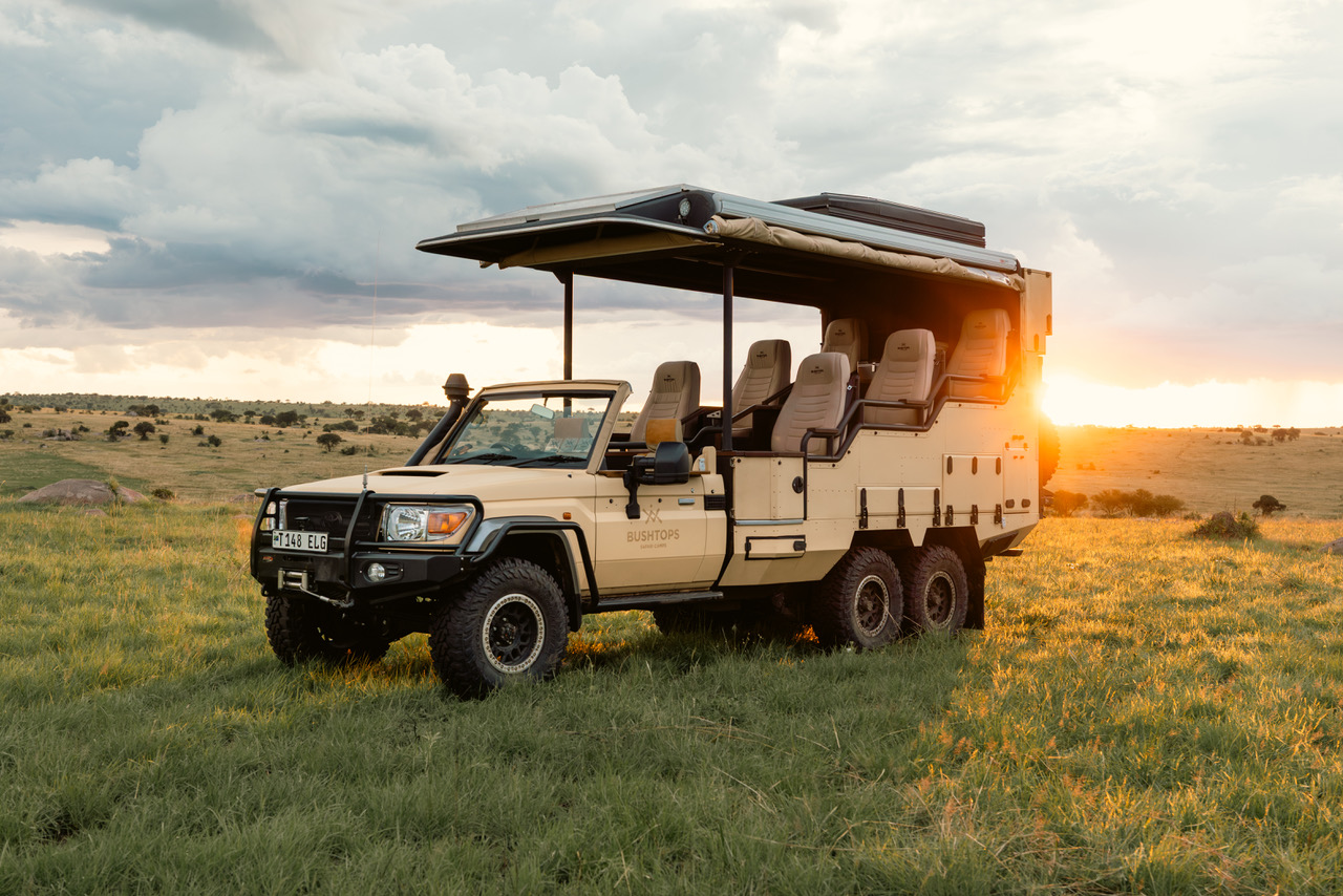 safari vehicle at sunset