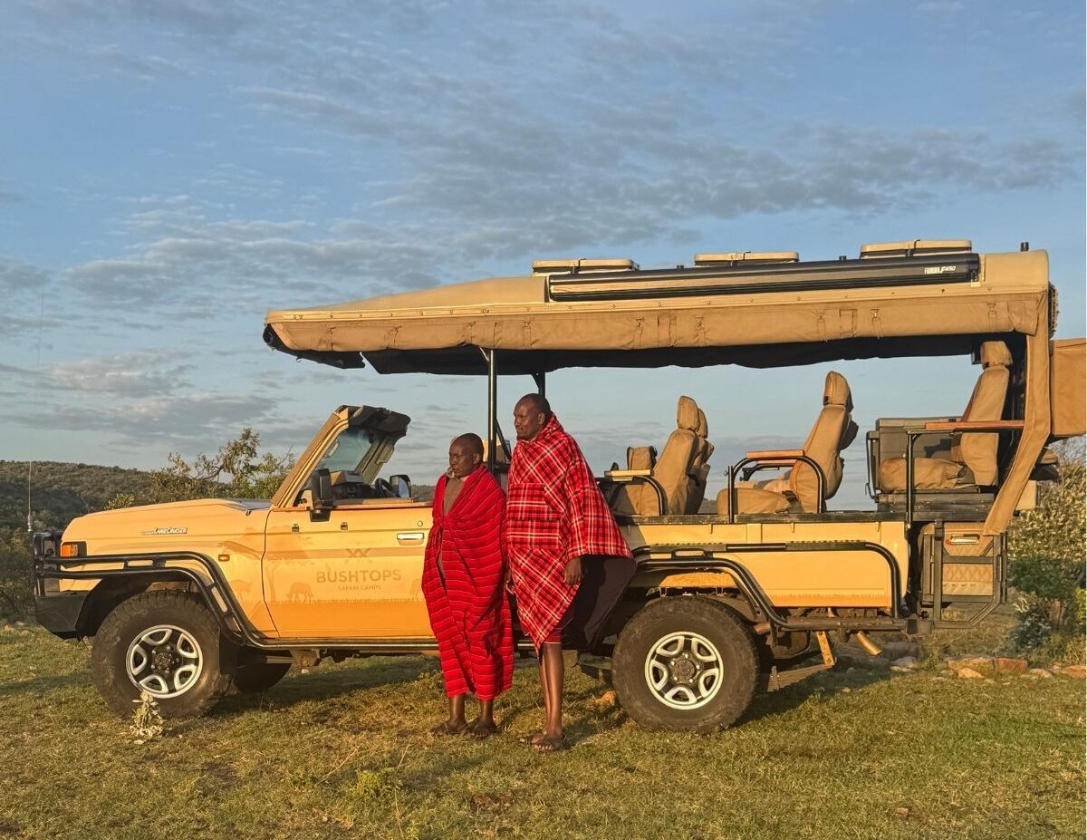 Maasai guides stand by Bushtops safari jeep