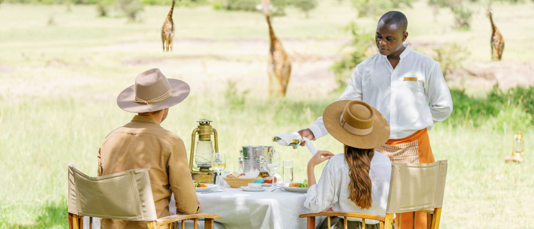 Couple enjoying lunch while watching wildlife in Africa