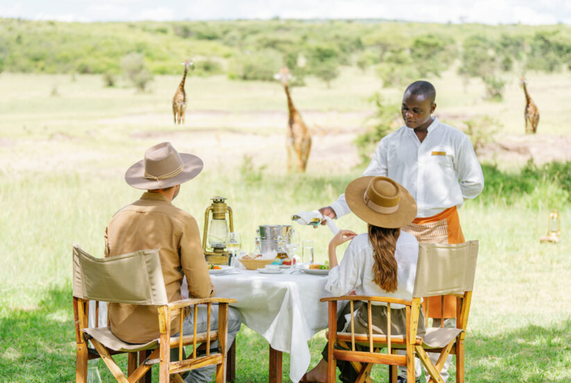 Couple enjoying lunch while watching wildlife in Africa